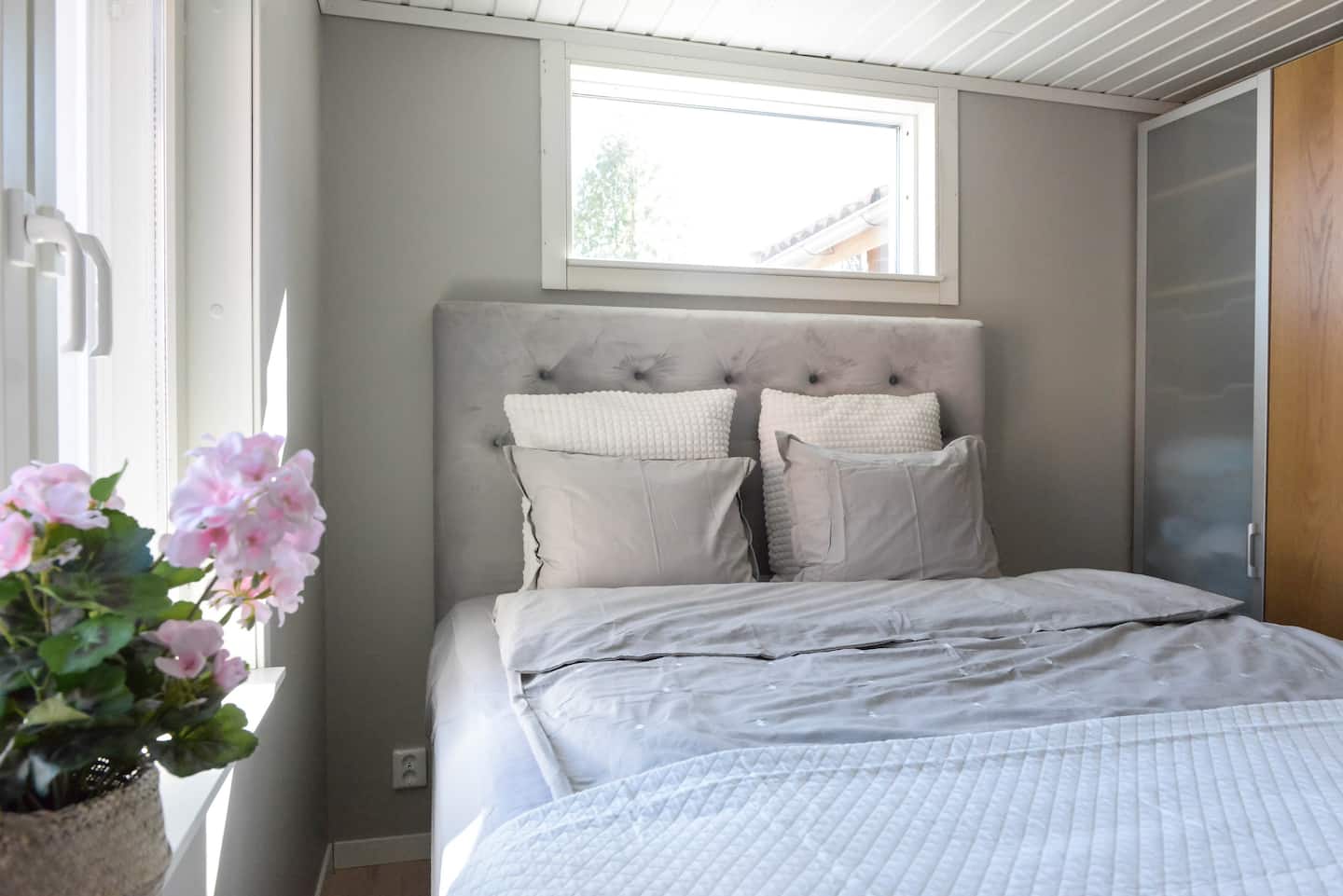Bedroom with flowers by the window