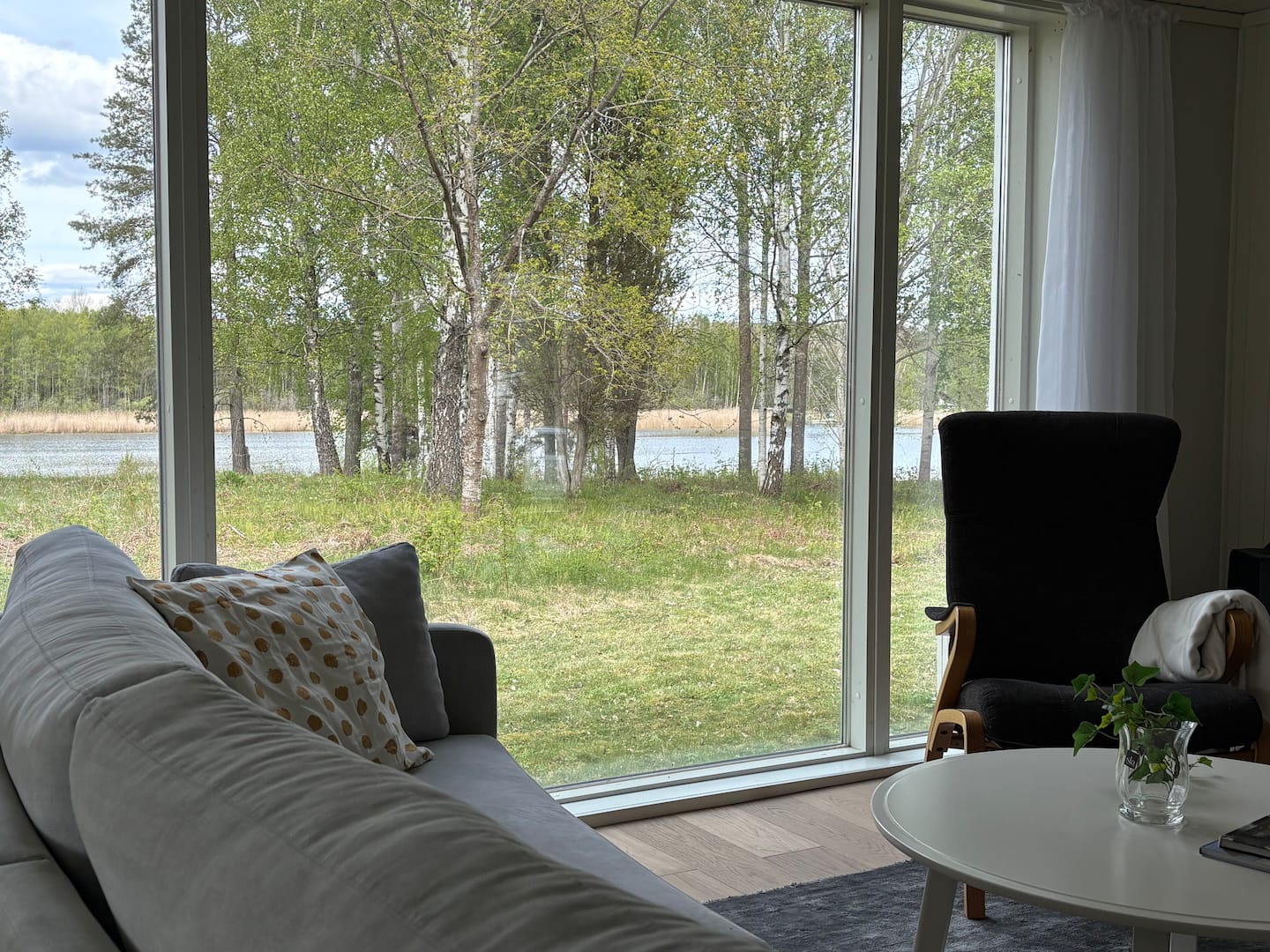 Sofa by the window with the water beyond