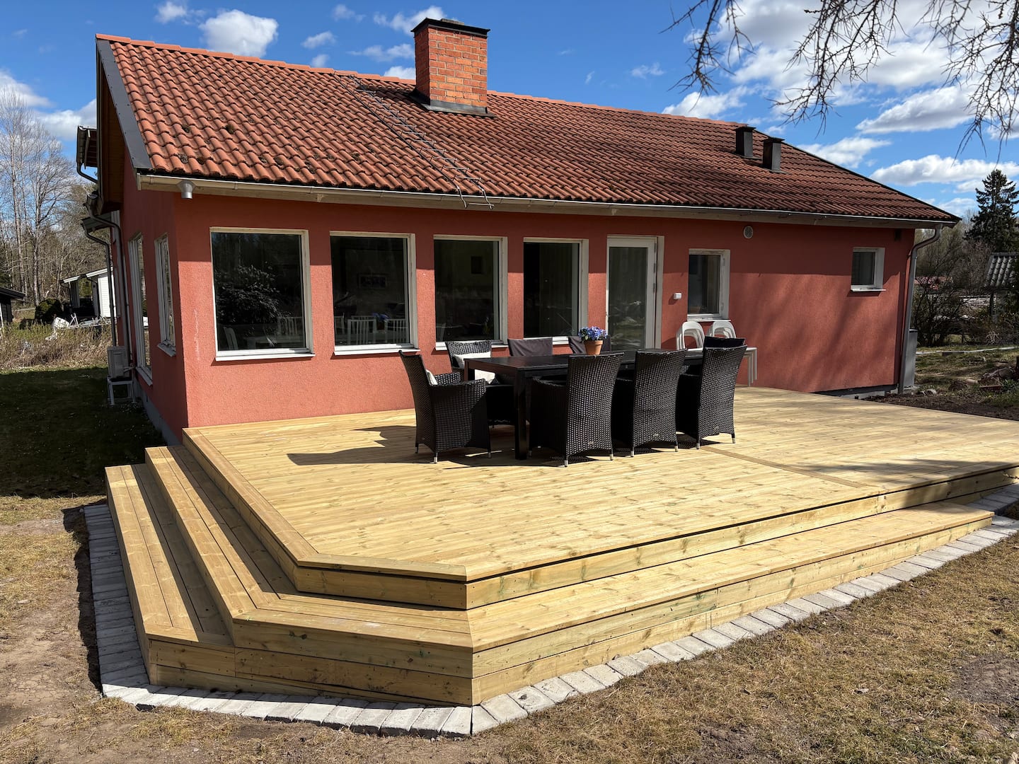The house and its large wooden deck
