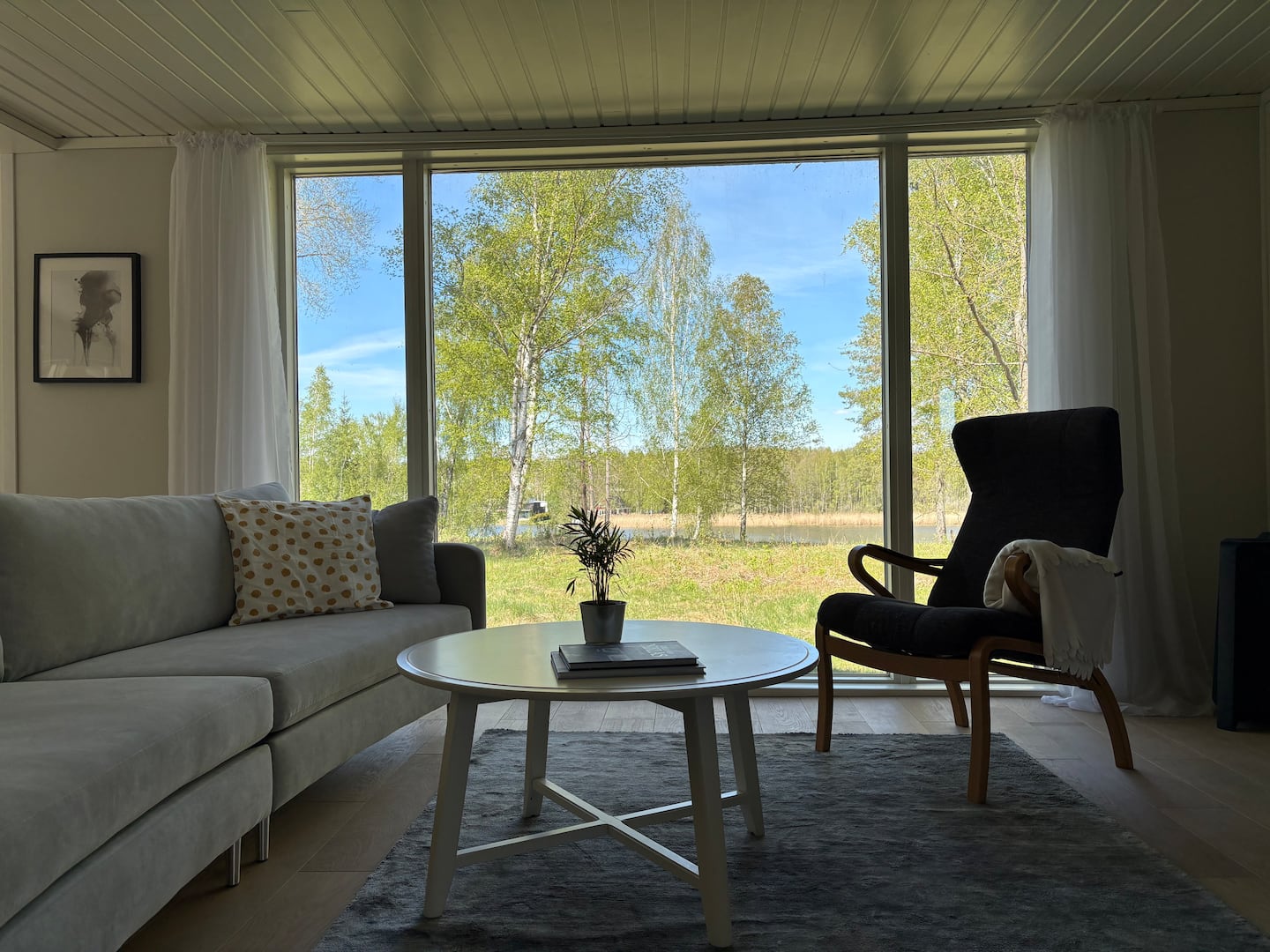 Deep sofa and armchairs facing the view